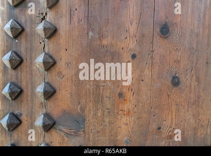 Part of the Valencia city ancient gates. Watch towers of Quart. Old wooden gate texture.   Strong fortress, Spain. Stock Photo