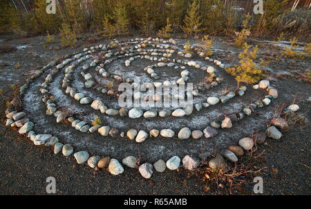 Meditative rock maze in the evening sun. Stock Photo