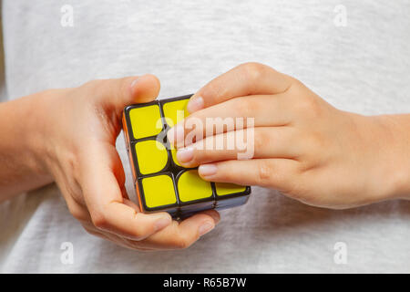 Kid playing with Rubik cube Stock Photo