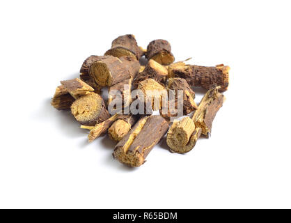 Dried medicinal herbs raw materials isolated on white. Root of Glycyrrhiza Stock Photo