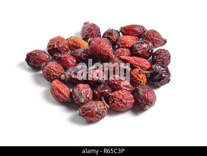 Dried medicinal herbs raw materials isolated on white. Dogrose or Rosa canina hips Stock Photo