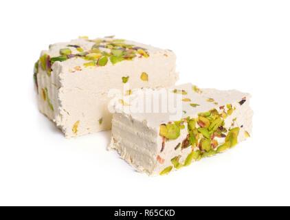 Tahini-based halva with pistachios. Isolated on white background. Stock Photo