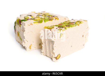 Tahini-based halva with pistachios. Isolated on white background. Stock Photo