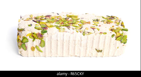 Tahini-based halva with pistachios. Isolated on white background. Stock Photo