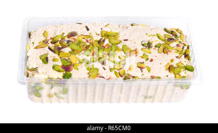 Tahini-based halva with pistachios. Isolated on white background. Stock Photo