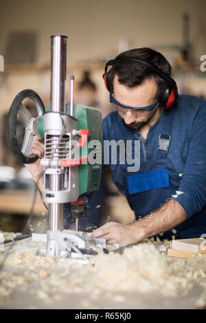 Worker Drilling Wood Stock Photo