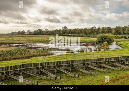 Schokland, The Netherlands, October 24, 2018: View from the northern mound on the former island towards the adjacent wetlands, witht the old emergency Stock Photo