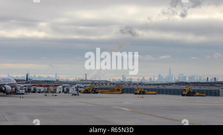 View of distant New York skyline with dramatic morning sunrise sky and Newark Liberty International Airport in the foreground Stock Photo