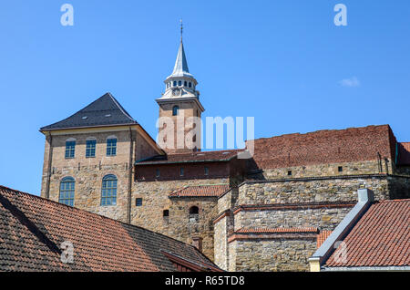 Castle tower with high buildings and walls in brick and stone, with red tile roofs at Akershus Castle and Fortress in Oslo, Norway Stock Photo