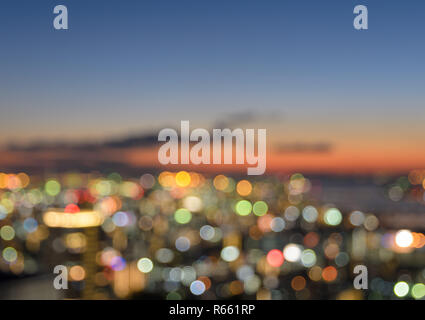 Aerial view of blurred bokeh cityscape at sunset Stock Photo