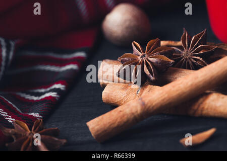 Anise star spices and cinnamon sticks on dark rystic wooden background Stock Photo