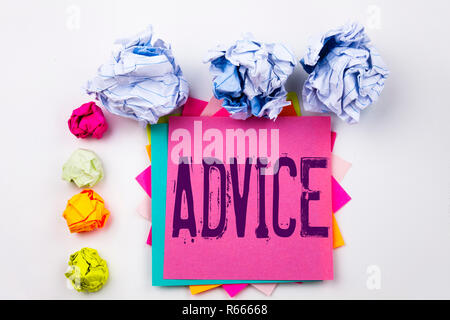 Writing text showing Advice written on sticky note in office with screw paper balls. Business concept for Suggestion guidance concept on the white isolated background. Stock Photo