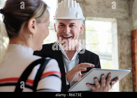 Woman Buying New Home And Talking To Broker Stock Photo