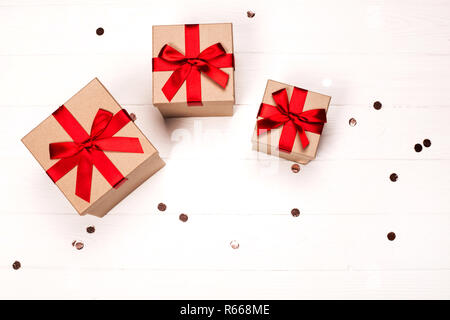 Flat lay concept for Christmas gift wrapping with beautiful red and white  striped gift box with big red bow, wrapping paper, ribbons, and decoration  l Stock Photo - Alamy