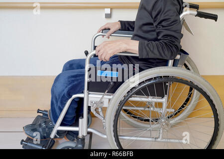 senior or elderly man sitting on wheelchair in hospital hallway Stock Photo