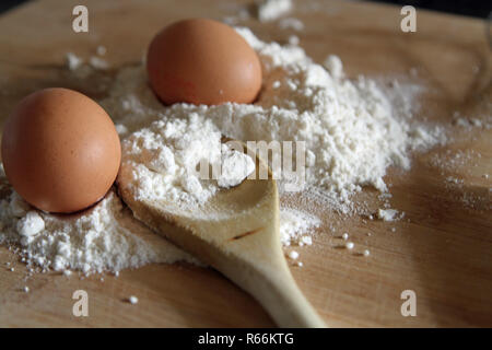 Wooden spoon and baking ingredients Stock Photo