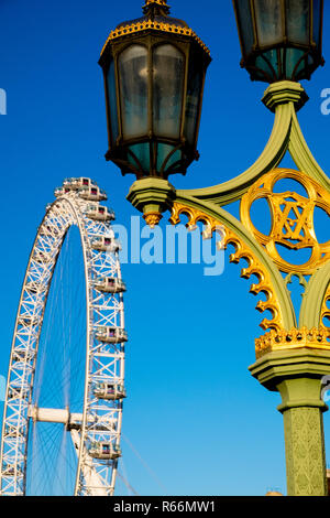Old street lamp and London Eye ferris wheel, London, UK. Stock Photo