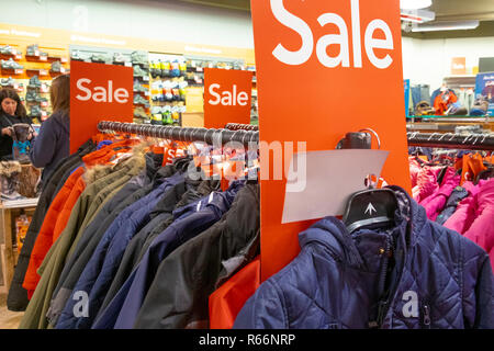 Sale signs on racks of clothes in a shop, UK Stock Photo