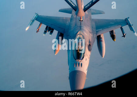 A 28th Expeditionary Aerial Refueling Squadron KC-135 Stratotanker refuels a U.S. Air Force F-16 Fighting Falcon in support of Operation Inherent Resolve, Nov. 29, 2018. The F-16 Fighting Falcon is a compact, multi-role fighter aircraft that has proven itself in air-to-air combat and air-to-surface attack.  (U.S. Air Force photo by Staff Sgt. James Cason) Stock Photo