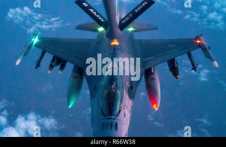 A 28th Expeditionary Aerial Refueling Squadron KC-135 Stratotanker refuels a U.S. Air Force F-16 Fighting Falcon in support of Operation Inherent Resolve, Nov. 29, 2018. The 28th EARS empowers the fight against ISIS by providing mission extending aerial refueling services to U.S. and coalition forces conducting operations in OIR's area of responsibility. (U.S. Air Force photo by Staff Sgt. James Cason) Stock Photo