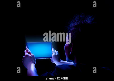 Rear view of male hands holding tablet with blue screen. Technology concept Stock Photo