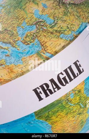 the word fragile written on a globe Stock Photo