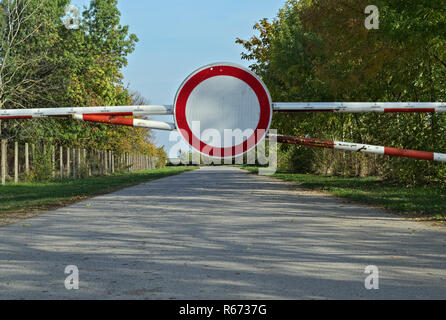 Stop sign closing the road through woods Stock Photo