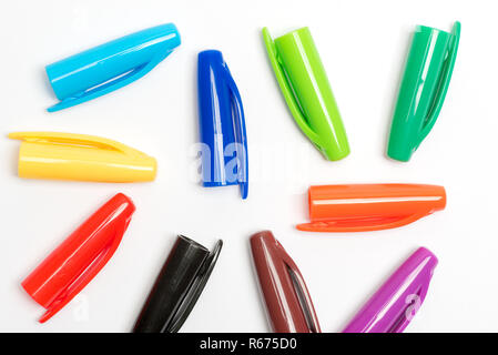 Colourful plastic pen lids on white background Stock Photo