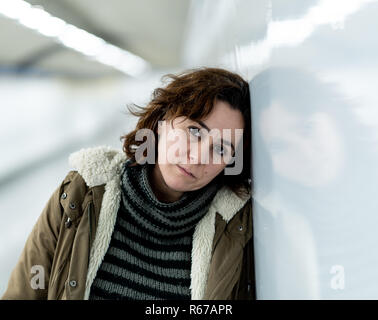 Hopeless and exhausted woman suffering depression and anxiety in subway tunnel in Work-life balance issues Negative body image Financial troubles and  Stock Photo