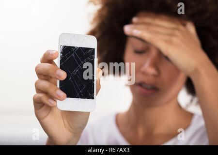 Woman Holding Broken Mobile Phone Stock Photo