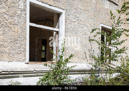 two broken windows in an abandoned house outdoor closeup Stock Photo