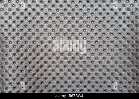 light brown quilted leather upholstery for furniture as background indoor closeup Stock Photo