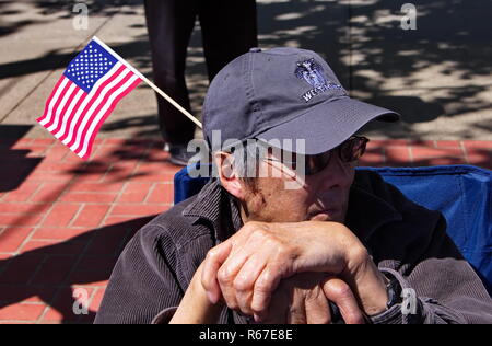 Middletown, CT USA. May 2018. Old veteran and a flag in his hat watching a Memorial Day parade honoring his brothers who made the ultimate sacrifice. Stock Photo