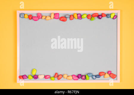 colored pebbles  on a colored background Stock Photo