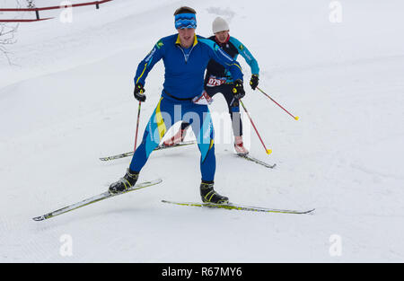 ALMATY, KAZAKHSTAN - FEBRUARY 18, 2017: amateur competitions in the discipline of cross-country skiing, under the name of ARBA Ski Fest. closeup feet  Stock Photo
