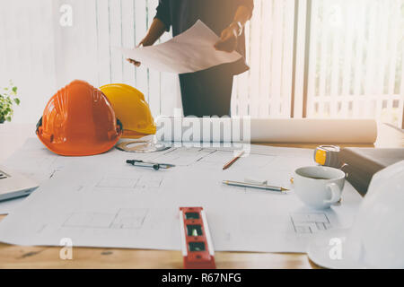 Confident team of architect working together in a office.Then discussing about new startup project on desk. Architect discuss with engineer about proj Stock Photo