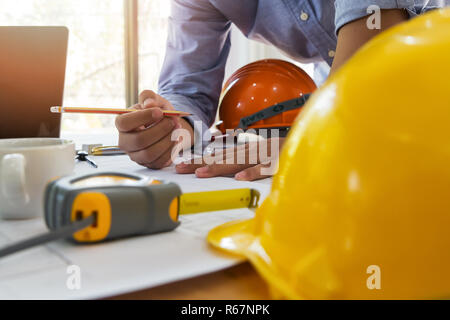Architect or engineer working on blueprint in office, architectural concept Stock Photo