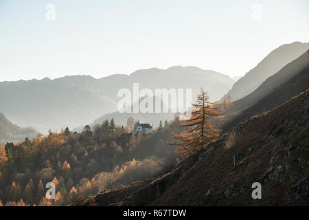 Beautiful Autumn Fall landscape view from Catbells in Lake District towards peaks of Grizedale, Grasmoor and Glaramara in the distance through hazy la Stock Photo