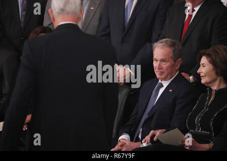 Former U.S. President George W. Bush looks up at Vice President Mike Pence as he walks back to his seat past Bush and his wife former first lady Laura Bush after Pence spoke about the president's father former President George H.W. Bush during ceremonies in the U.S. Capitol Rotunda in Washington, U.S., December 3, 2018. Pool Via CNP/MediaPunch Stock Photo