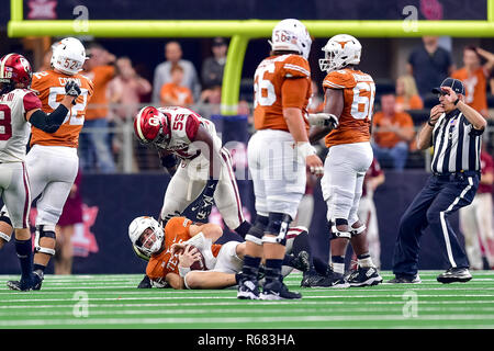 Texas Longhorns running back Keaontay Ingram (26) is stopped behind the  line by Oklahoma defensive lineman Kenneth Mann (55) during the Dr. Pepper  Big-12 Championship between the Oklahoma Sooners vs Texas Longhorns