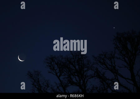 Pitlochry,UK. 4th December 2018. WEATHER. A waning crescent Moon and the planet Venus, seen in a clear dawn sky in Perthshire, Scotland.Credit: Allan Milligan/Alamy Live News Stock Photo