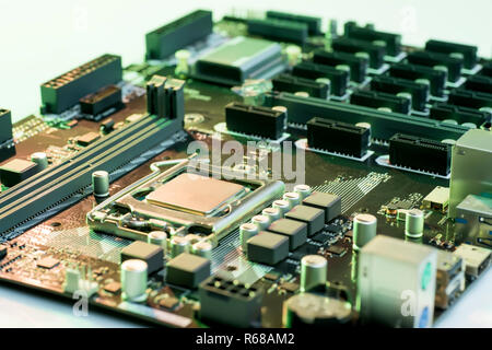 Close up view of computer motherboard with processor, memory and PCI slots on the table Stock Photo