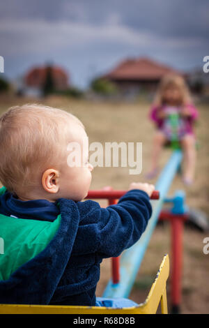 Boy and girl on a swing Stock Photo