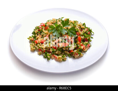 Tabbouleh salad with burghul or bulgur. On white plate. Stock Photo