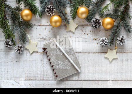 Christmas style border with a space for text or product with a notebook for writing new years resolutions Stock Photo