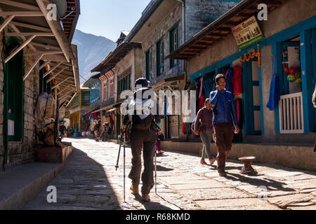 Nepal, Lukla, senior female walker entering town at end of Everest Base Camp Trek Stock Photo