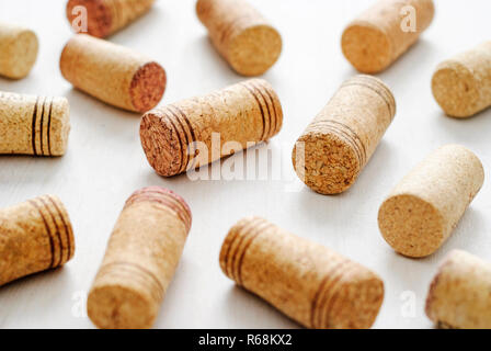 Wine bottle corks decorated with stripes, sitting on white surface, viewed from high angle in closeup Stock Photo