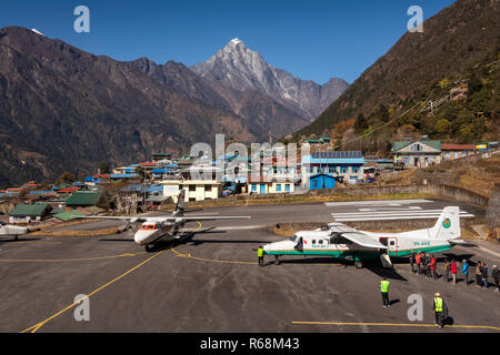 Nepal, Lukla, airport, passengers boarding Tara Air Dornier 228-212 aircraft as Summit Air Let L-410 Turbolet arrives Stock Photo