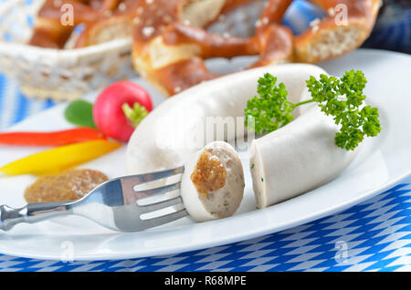 Typical Bavarian white sausages with pretzels and sweet mustard Stock Photo