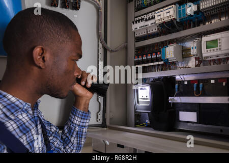 Electrician Examining A Electric Meter Stock Photo